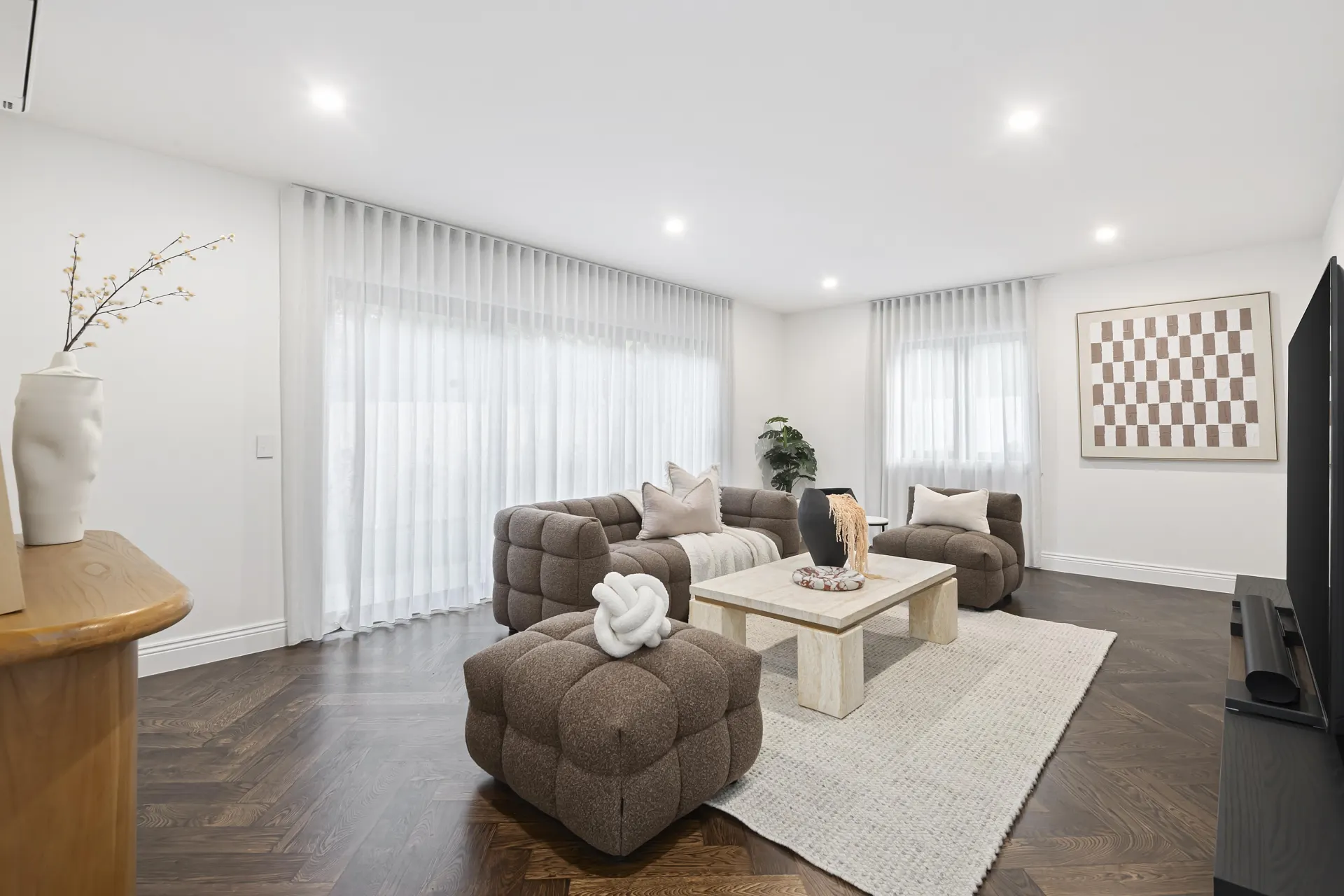 Living room with dark engineered oak herringbone flooring, supplied and installed by TMBR in Doncaster East