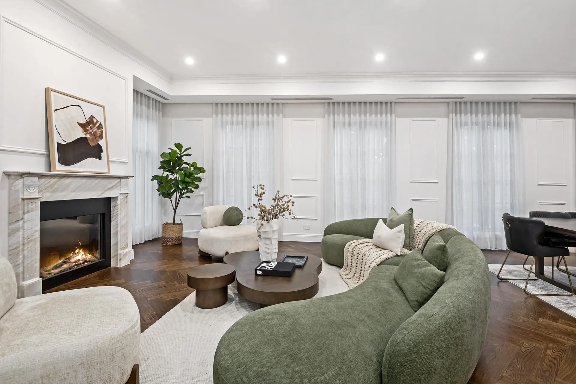 Lounge room with timber-look herringbone flooring and marble fireplace from a TMBR project in Doncaster East