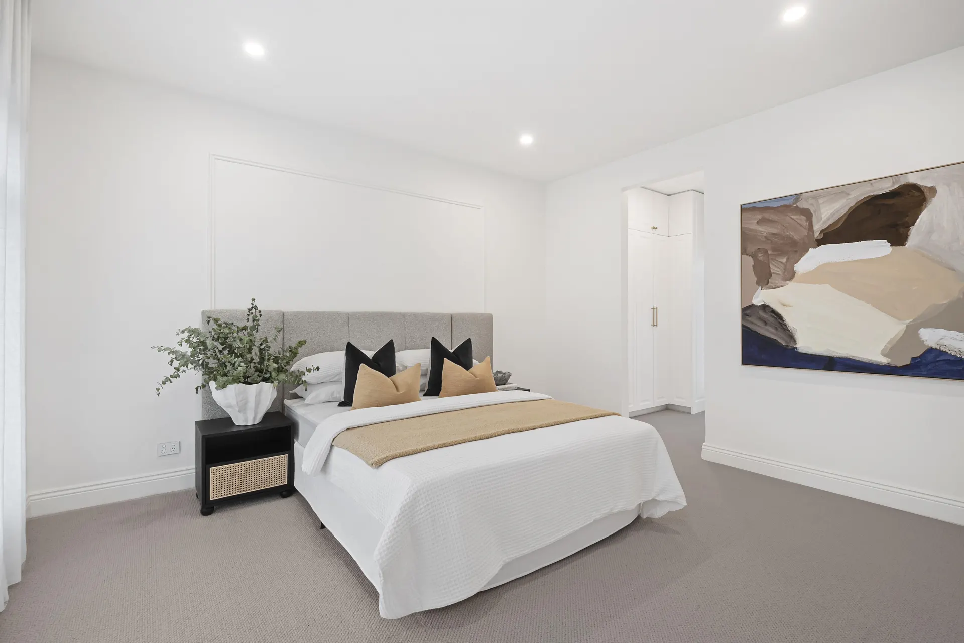 Bedroom with soft wool carpet and grey upholstered headboard