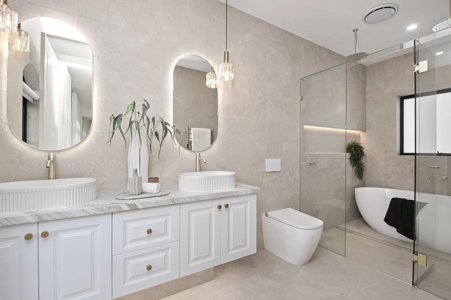 Main bathroom with freestanding bath and stone-look tiles