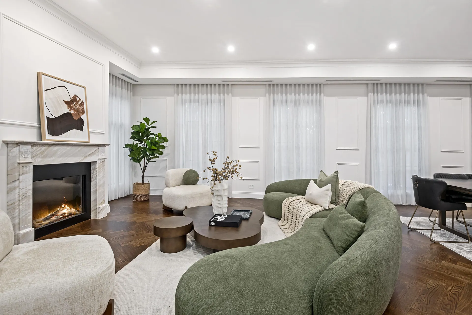 Formal living room with herringbone oak flooring and a marble fireplace.